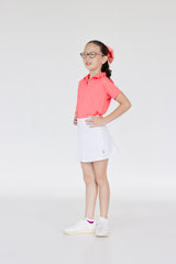Conjuto para golf de niña con falda blanca y polo rosa dryfit 