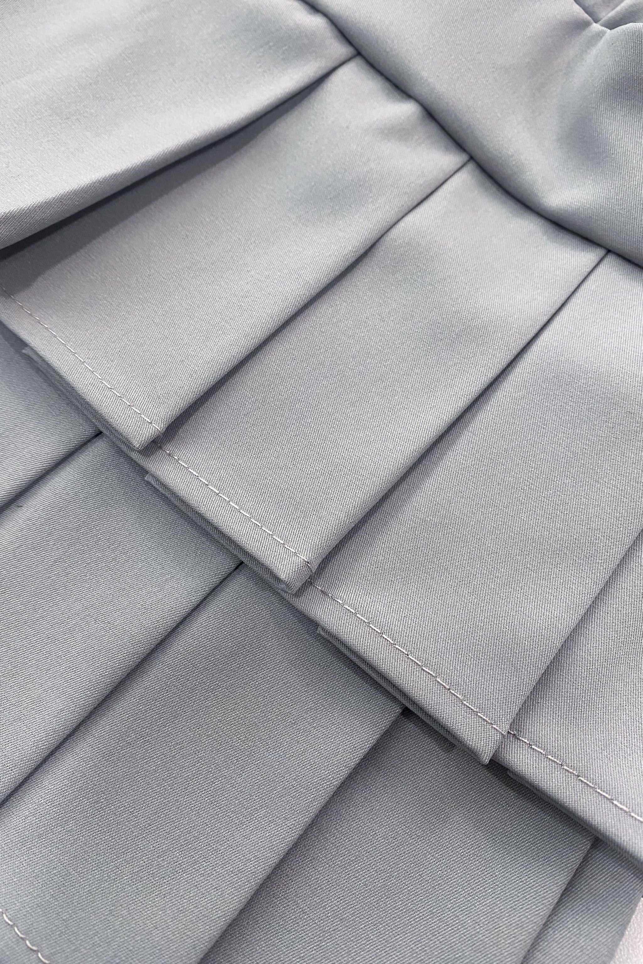 Falda gris con tablones y lycra dryfit para niña, golf pádel o tenis