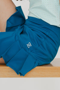 Falda para golf en talla de niña y dama con tablas, shorts y bolsa 