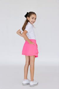 Falda de golf o peal para niña con corte tulipán, lycra dryfit y bolsa trasera, color rosa fosforescente