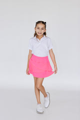 Falda de golf para niña corte tulipán color rosa fosforescente, con lycra dryfit y bolsillo trasero