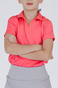 Polo de golf niña Zendra color coral con tecnología Dry y protección solar
