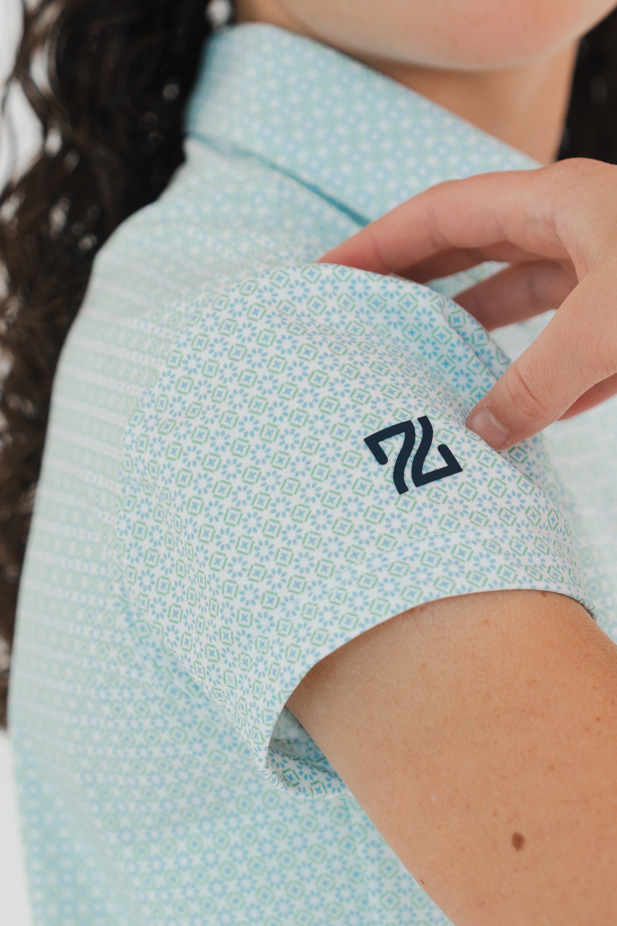 Detalle polo golf niña con tecnología de conservación de color